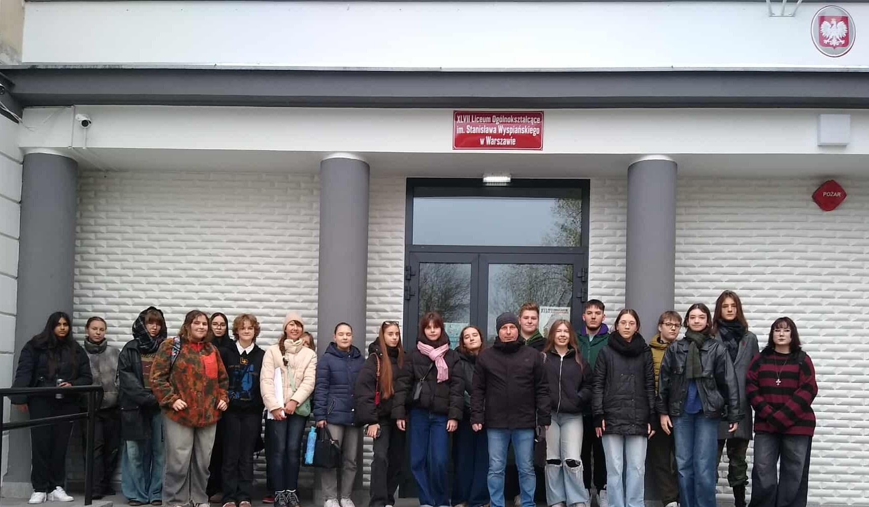 uczniowie z opiekunem przed budynkiem, w którym odbywał sie konkurs